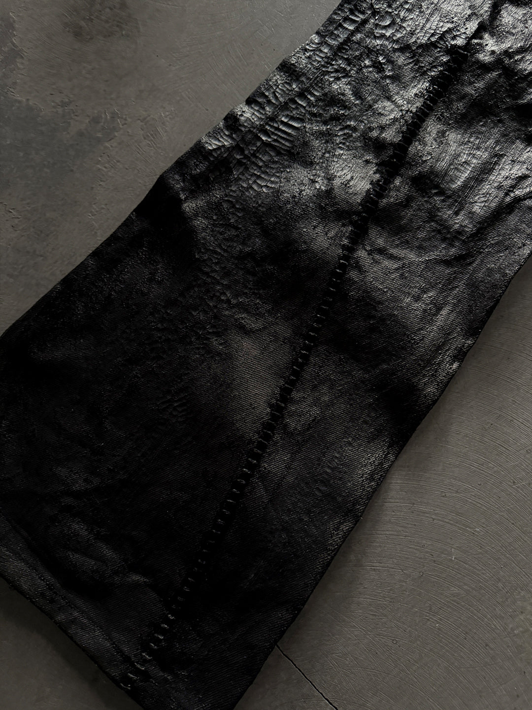 SERONINE CTX-55 wax-coated structural black jeans with scar-like stitching
