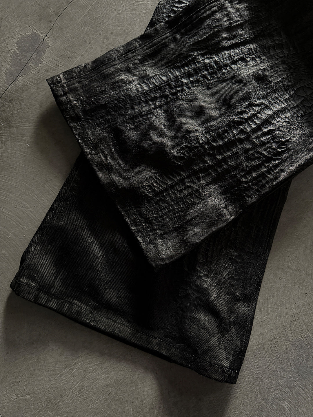 SERONINE CTX-55 wax-coated structural black jeans with scar-like stitching