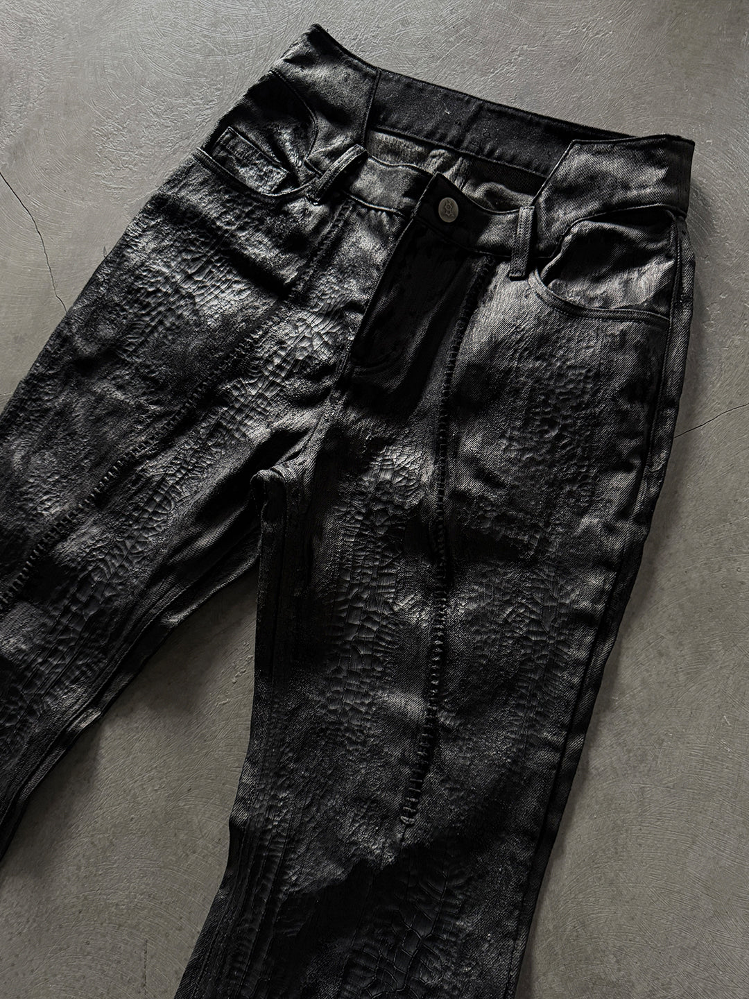 SERONINE CTX-55 wax-coated structural black jeans with scar-like stitching