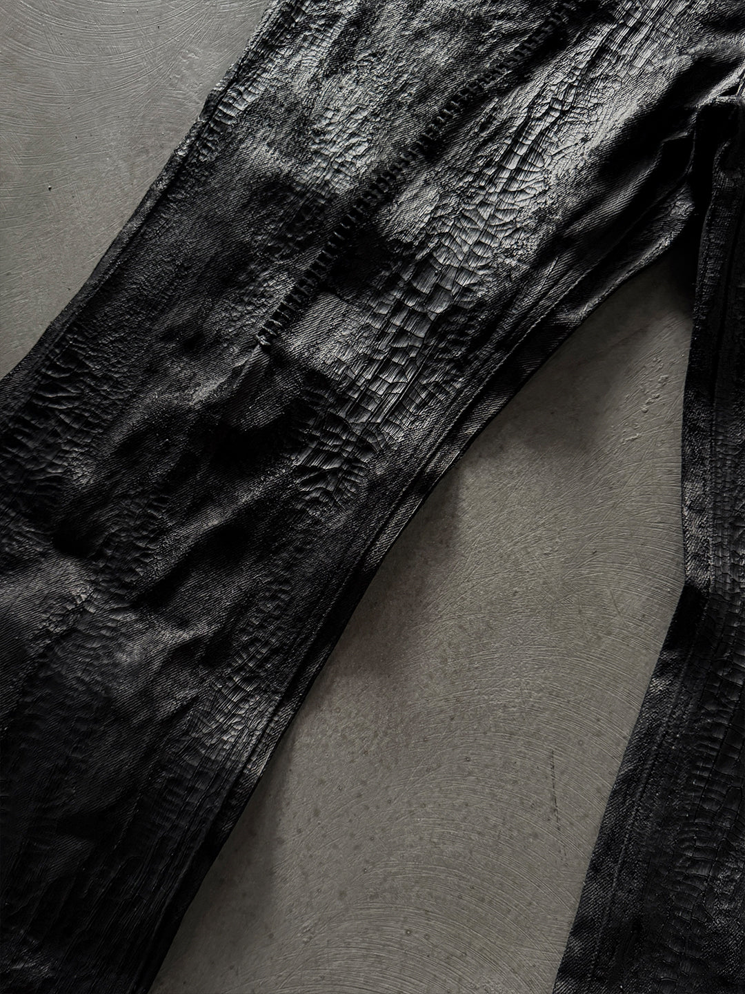 SERONINE CTX-55 wax-coated structural black jeans with scar-like stitching