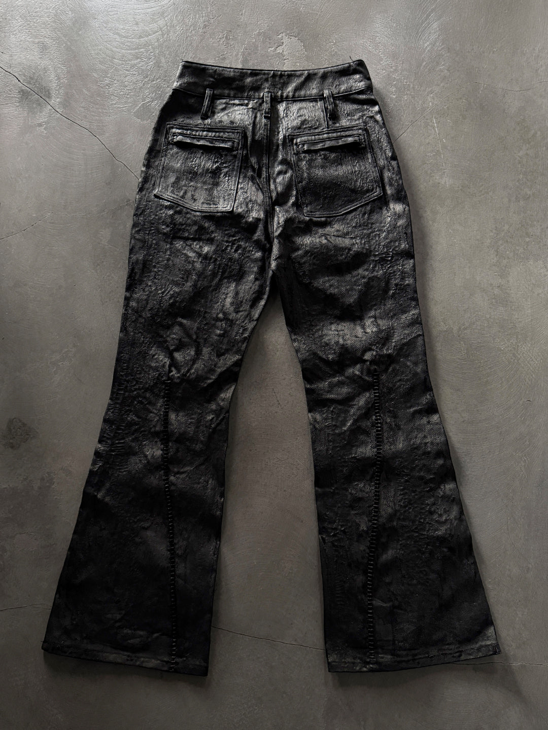 SERONINE CTX-55 wax-coated structural black jeans with scar-like stitching