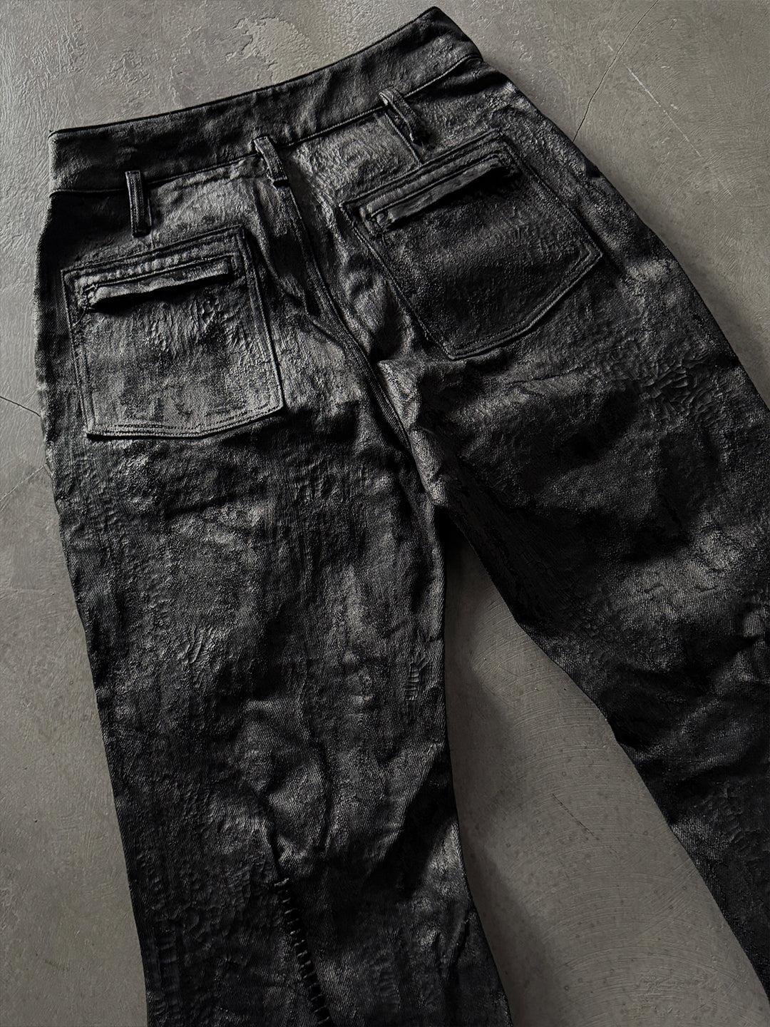 SERONINE CTX-55 wax-coated structural black jeans with scar-like stitching