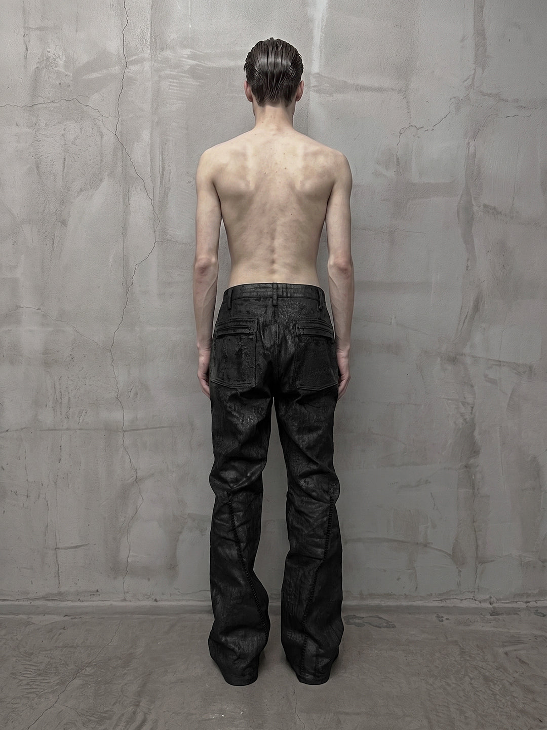 SERONINE CTX-55 wax-coated structural black jeans with scar-like stitching