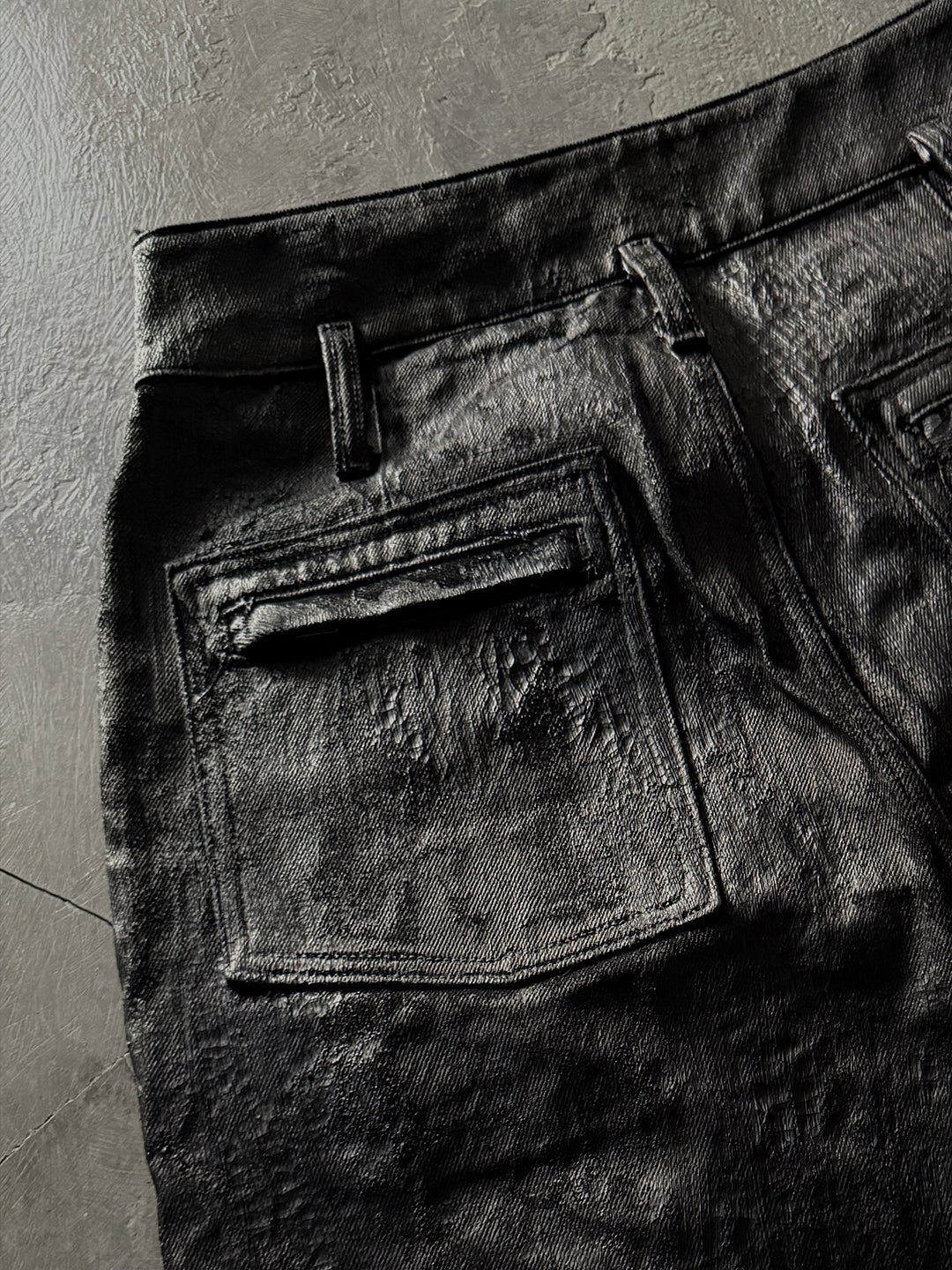 SERONINE CTX-55 wax-coated structural black jeans with scar-like stitching
